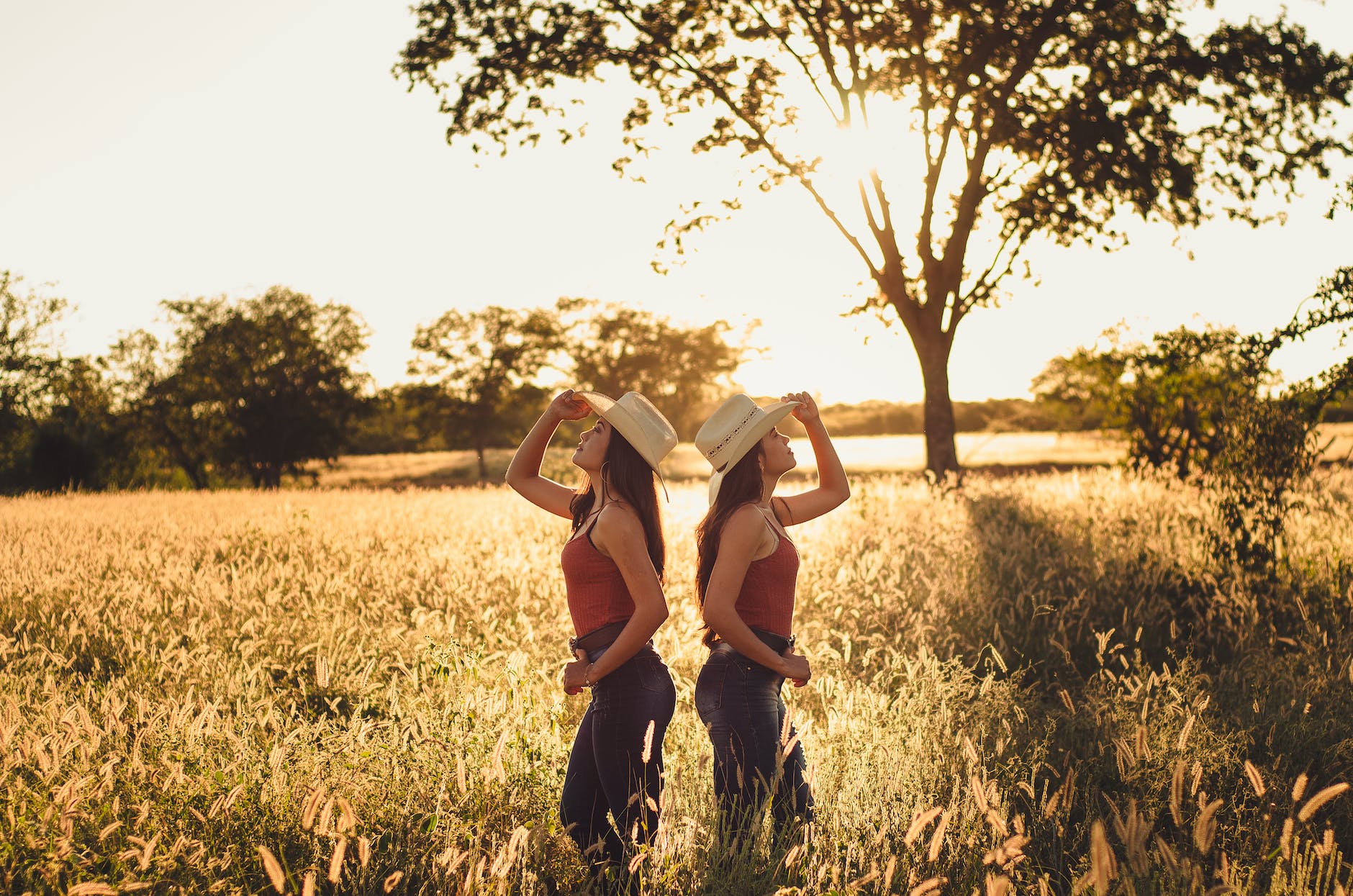 two women standing on grass field