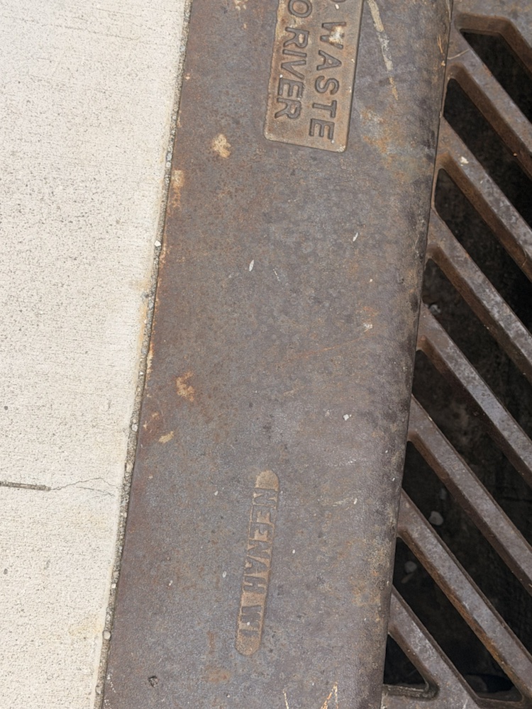 A close view of a curb edge and metal grate near Findlay Market.