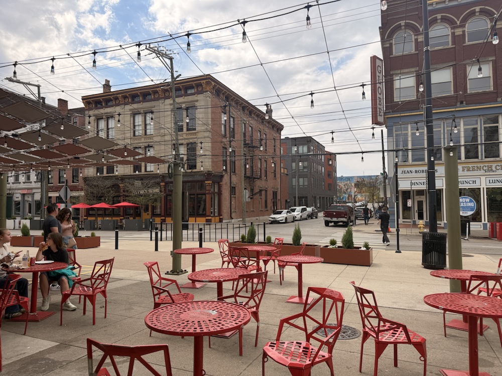 Red outdoor tables and chairs beside Findlay Market.