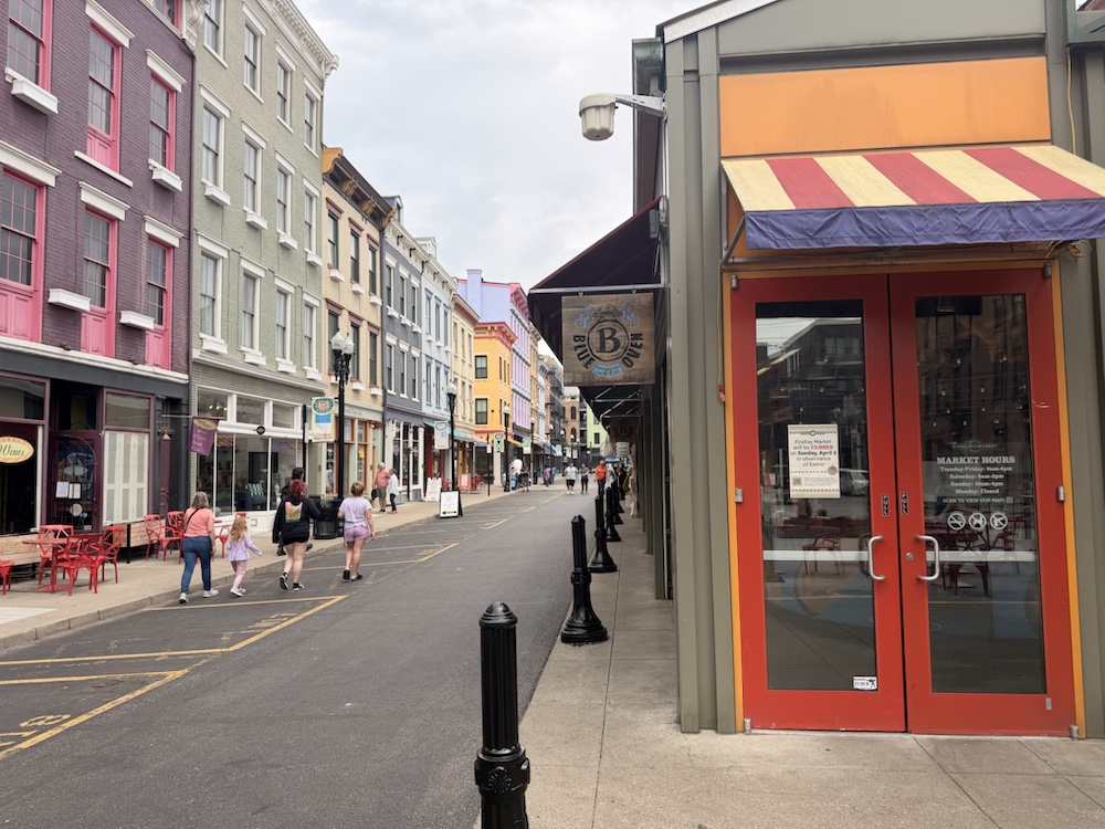 A corner storefront near Findlay Market with striped awnings and the street beyond.