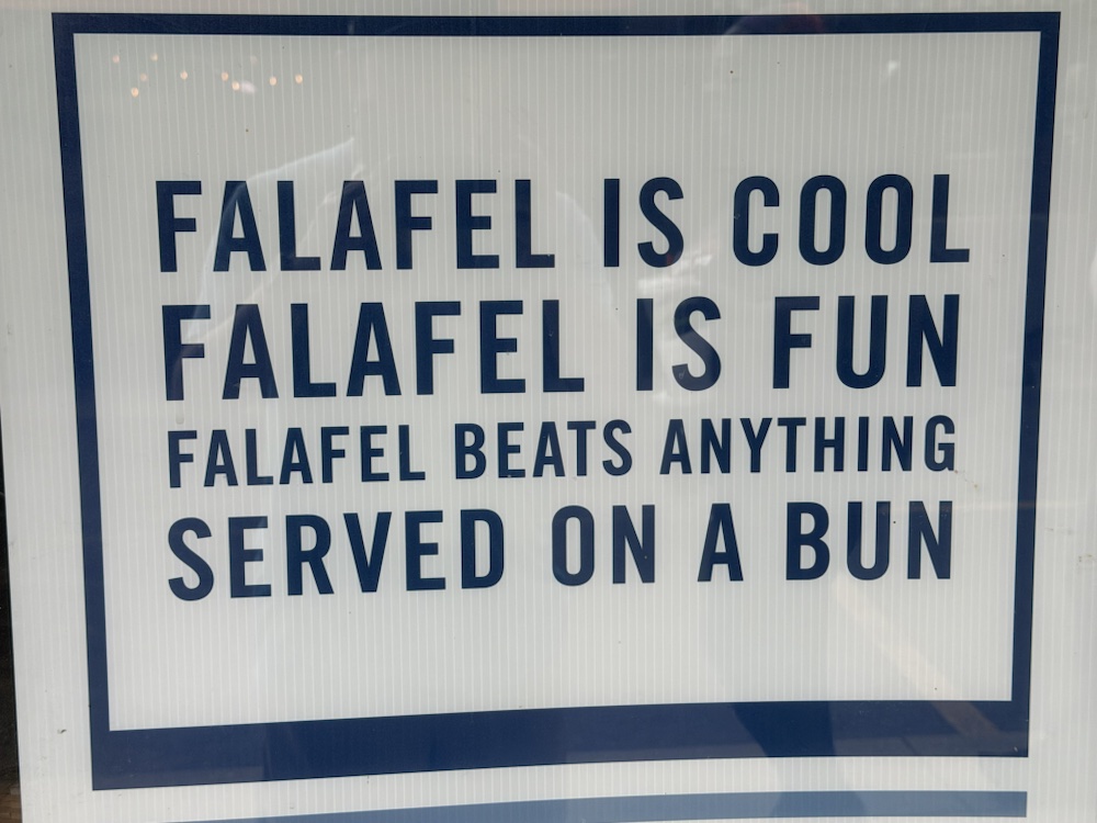 A sign reading Falafel is cool, falafel is fun, falafel beats anything served on a bun.